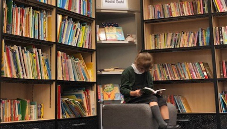 Girl writing in a classroom